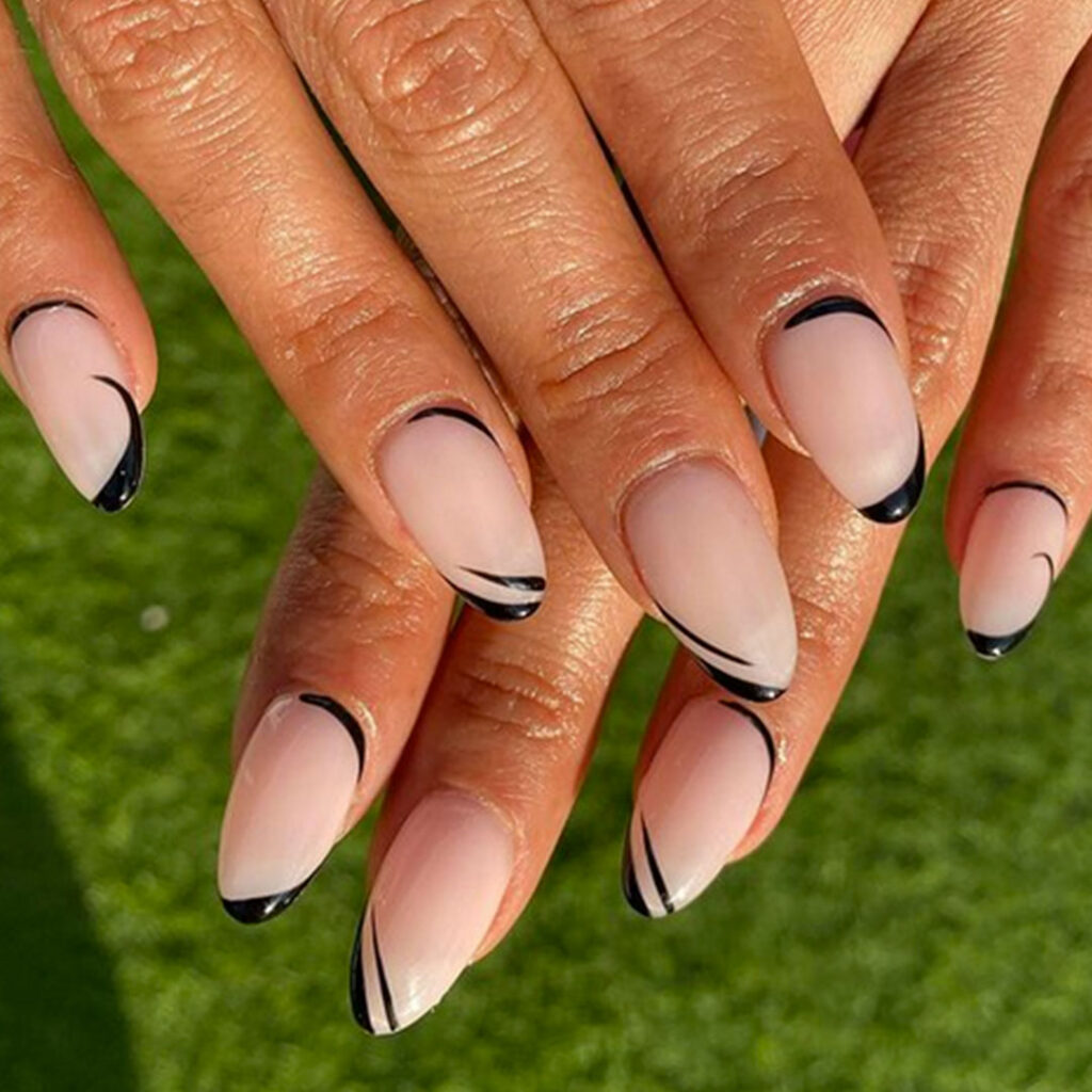 A woman with long nails and black lines on her fingers.