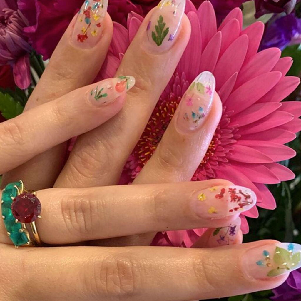 A close up of some nails with flowers on them